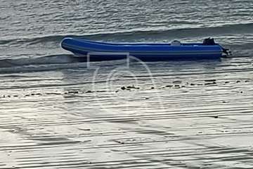 Una lancha neumática con varios jóvenes inmigrantes arriba a la playa de Ojos de Garza/TA.